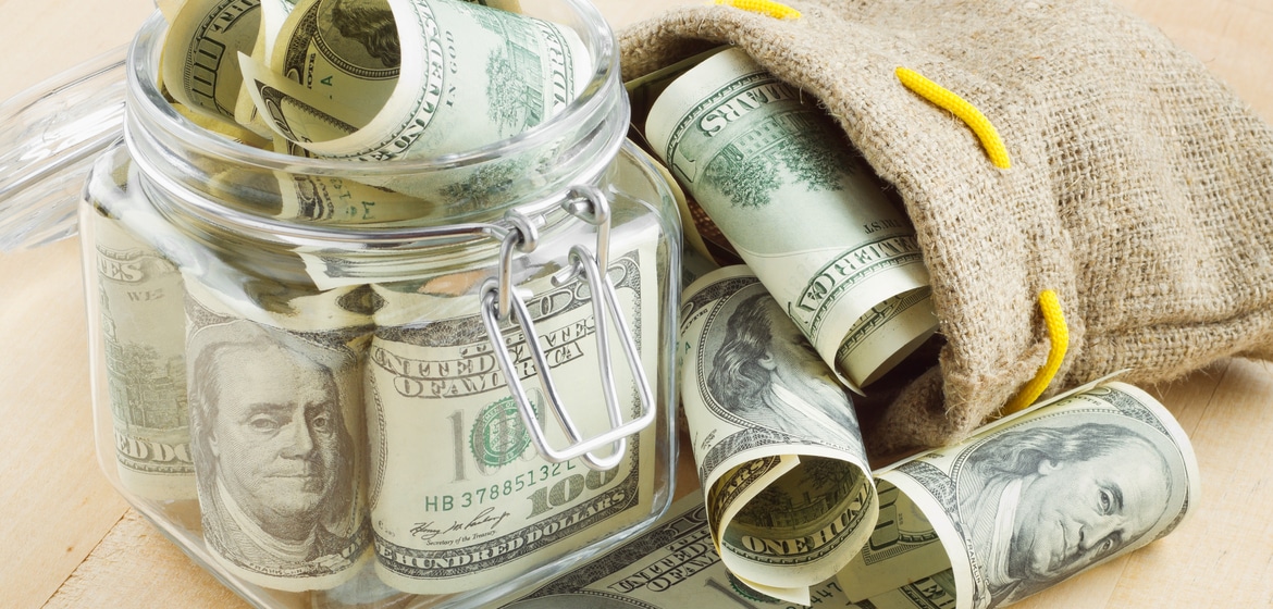 dollar banknote in glass jar and bag of money